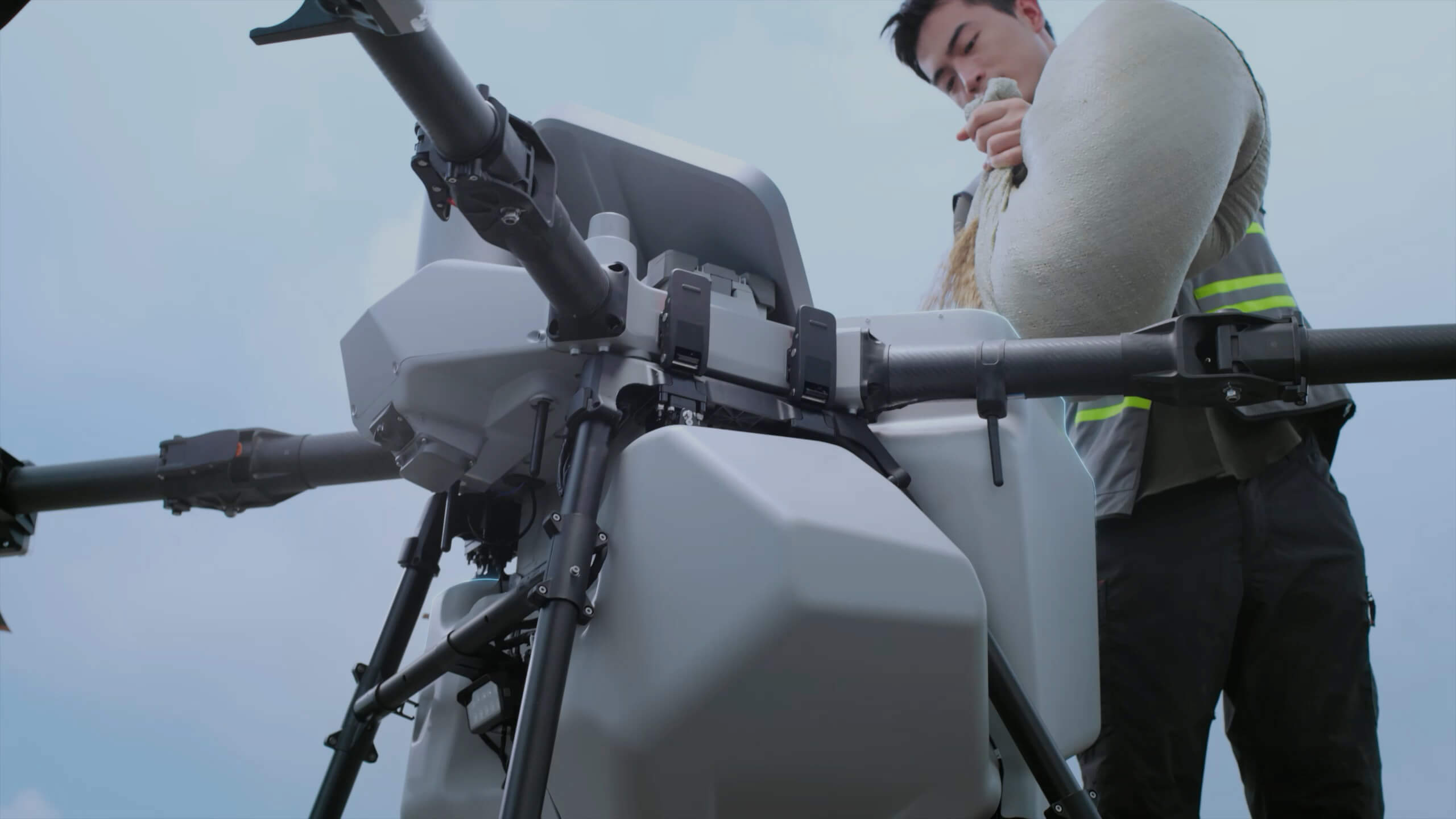 DJI AGRAS T100 spreading system being loaded with granular material